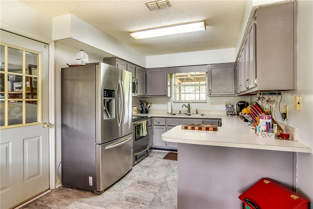 54014 Vikki Road Callahan, FL 32011 - Photo 9 of 29 a kitchen with stainless steel appliances granite countertop a refrigerator and a stove