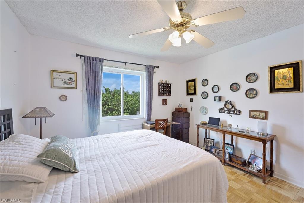 1010 Manatee Road, Unit B201 Naples, FL 34114 - Photo 11 of 24 a bedroom with a bed dresser and a window