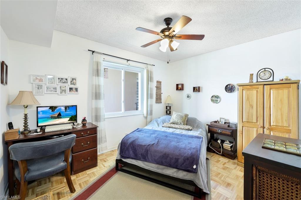 1010 Manatee Road, Unit B201 Naples, FL 34114 - Photo 13 of 24 a bedroom with a bed and furniture