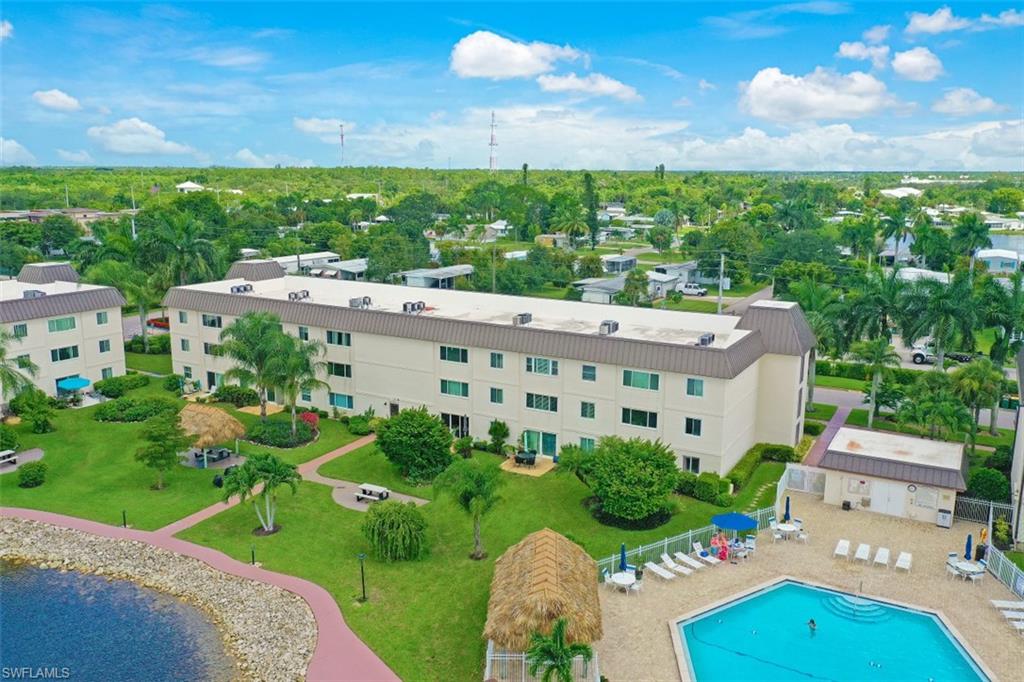 1010 Manatee Road, Unit B201 Naples, FL 34114 - Photo 19 of 24 a view of a garden with a large pool table and chairs