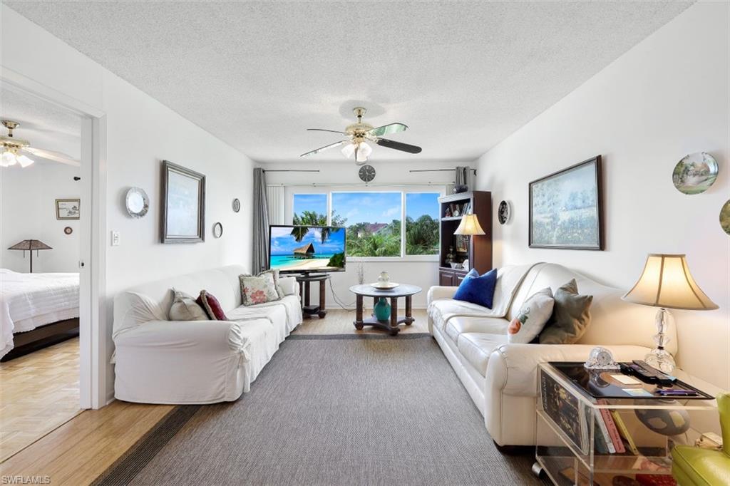 1010 Manatee Road, Unit B201 Naples, FL 34114 - Photo 2 of 24 a living room with furniture and a chandelier