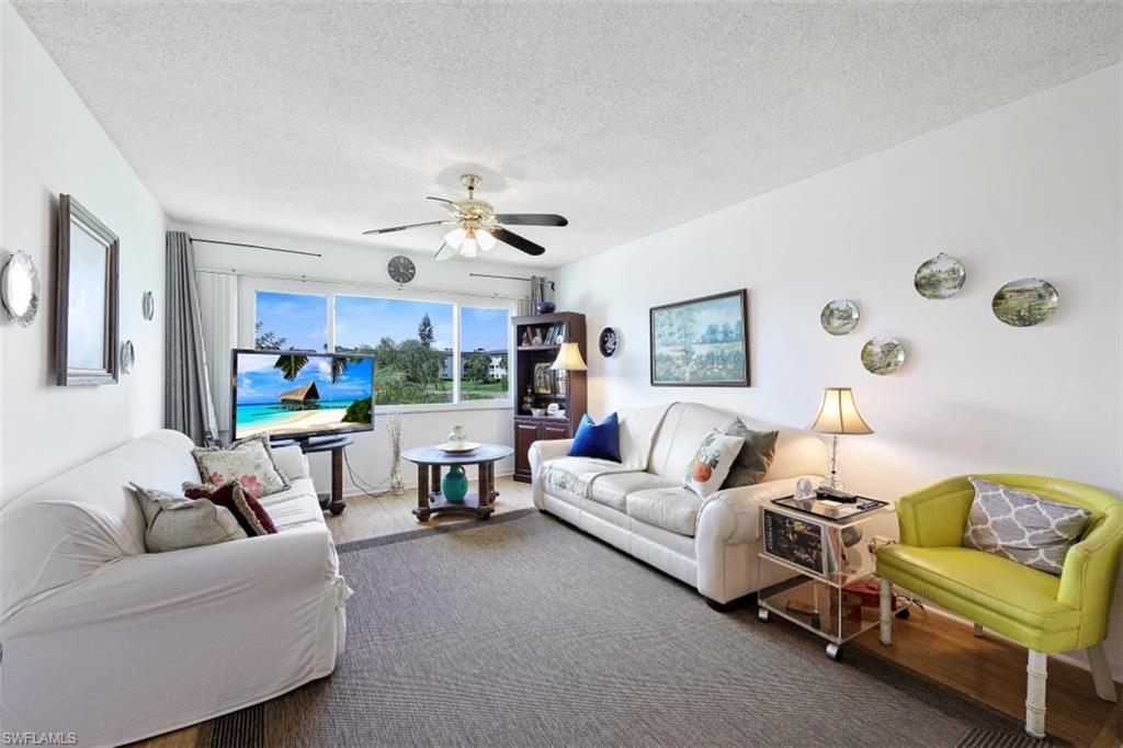1010 Manatee Road, Unit B201 Naples, FL 34114 - Photo 3 of 24 a living room with furniture and a large window