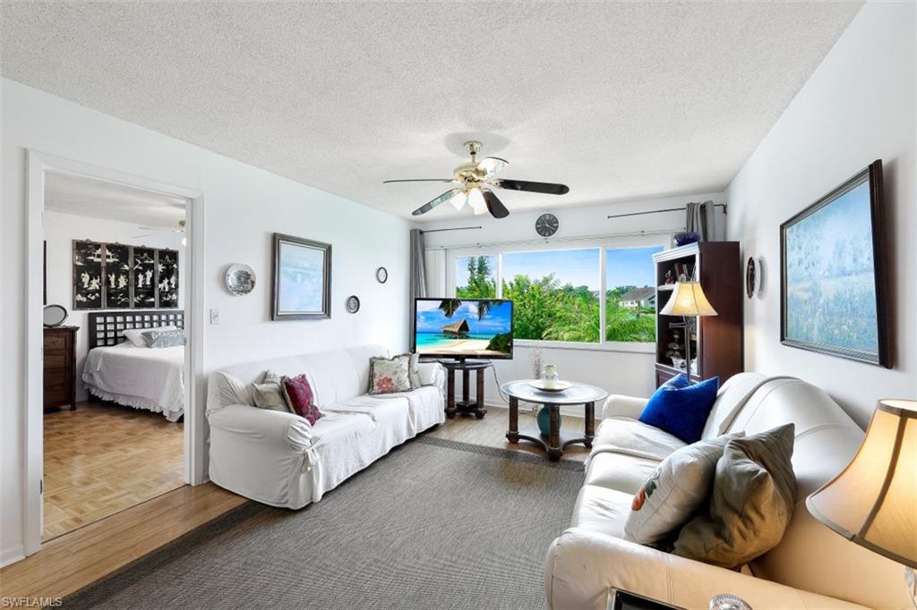 1010 Manatee Road, Unit B201 Naples, FL 34114 - Photo 4 of 24 a living room with furniture and a large window