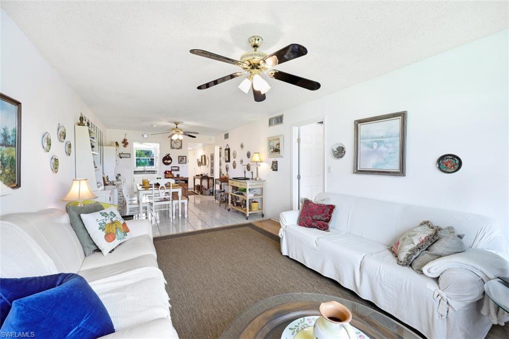 1010 Manatee Road, Unit B201 Naples, FL 34114 - Photo 5 of 24 a living room with furniture and a wooden floor