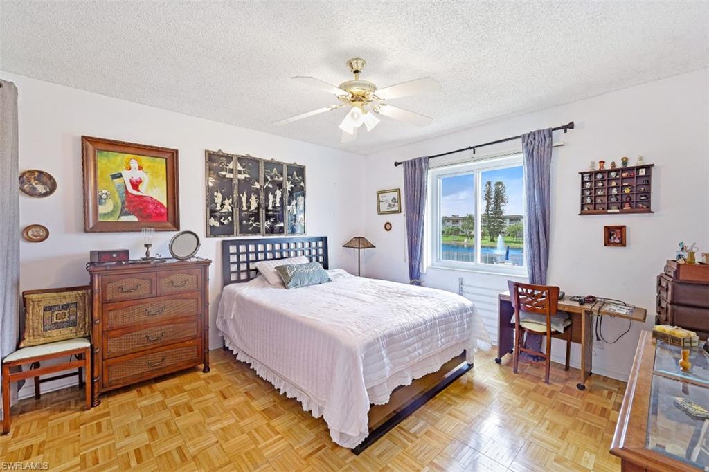 1010 Manatee Road, Unit B201 Naples, FL 34114 - Photo 10 of 24 a bedroom with a bed and furniture