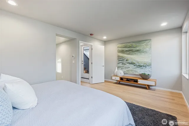 a bedroom with a bed and a large window