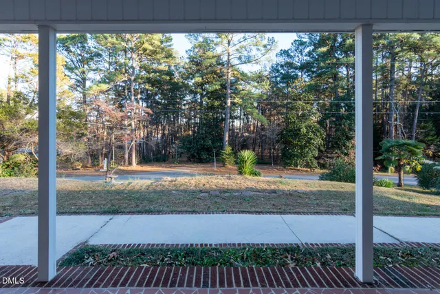 a view of a livingroom with a fireplace and large windows