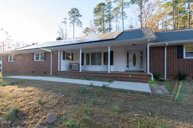 a view of an empty room with a fireplace and a window