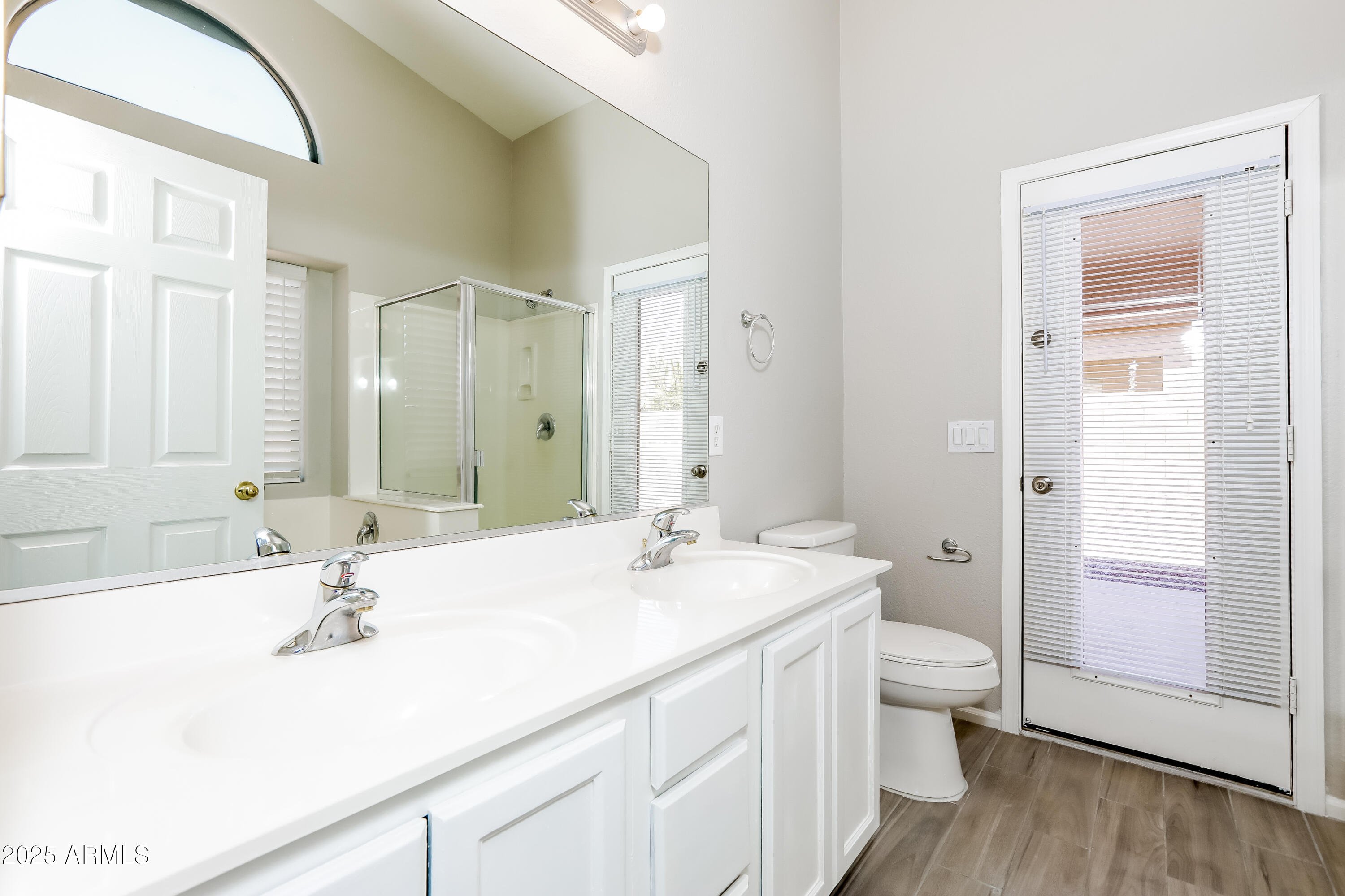 42430 Chambers Drive Maricopa, AZ 85138 - Photo 13 of 15 a bathroom with a sink and a large mirror