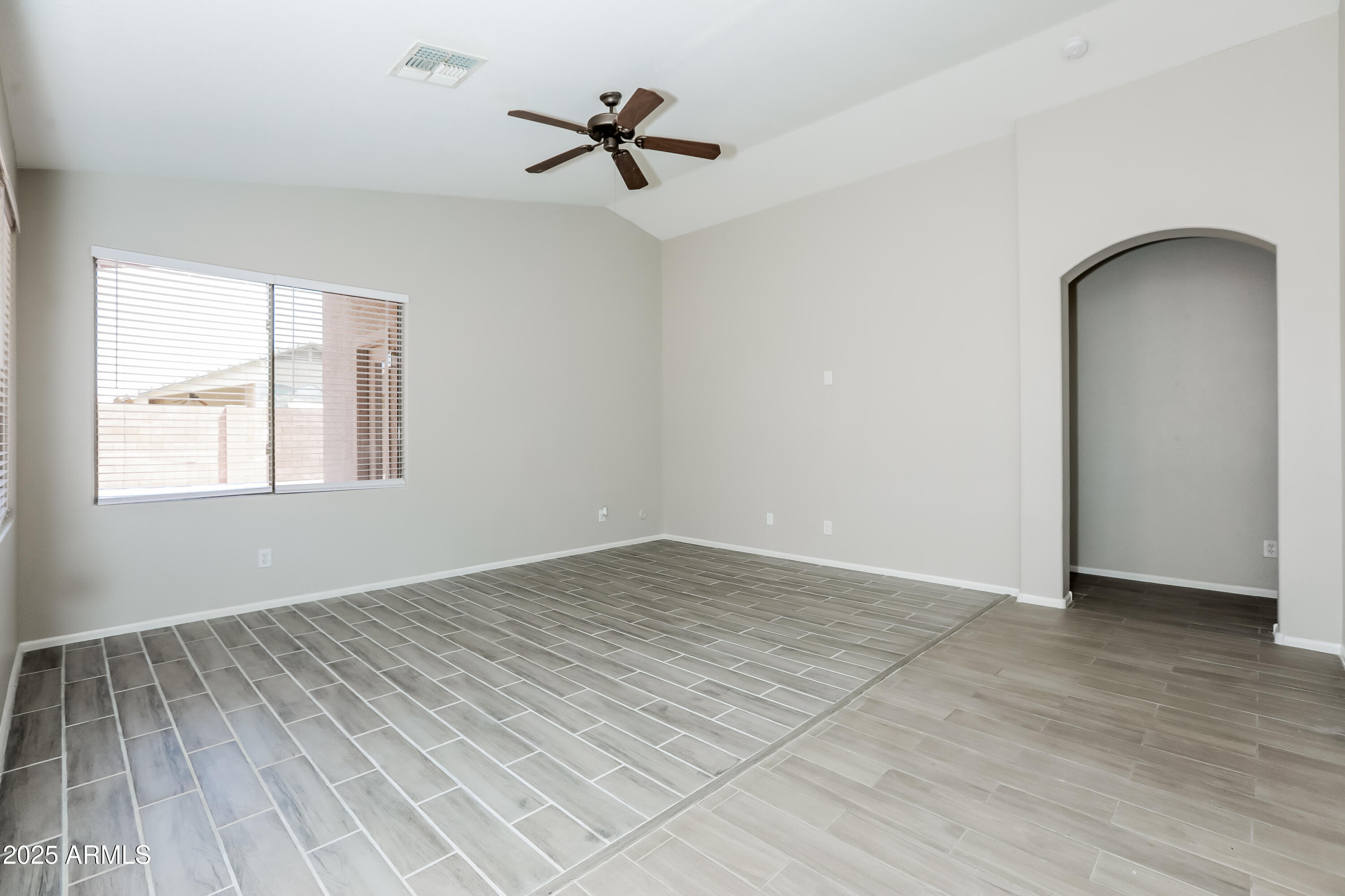 42430 Chambers Drive Maricopa, AZ 85138 - Photo 3 of 15 a view of empty room with wooden floor and fan