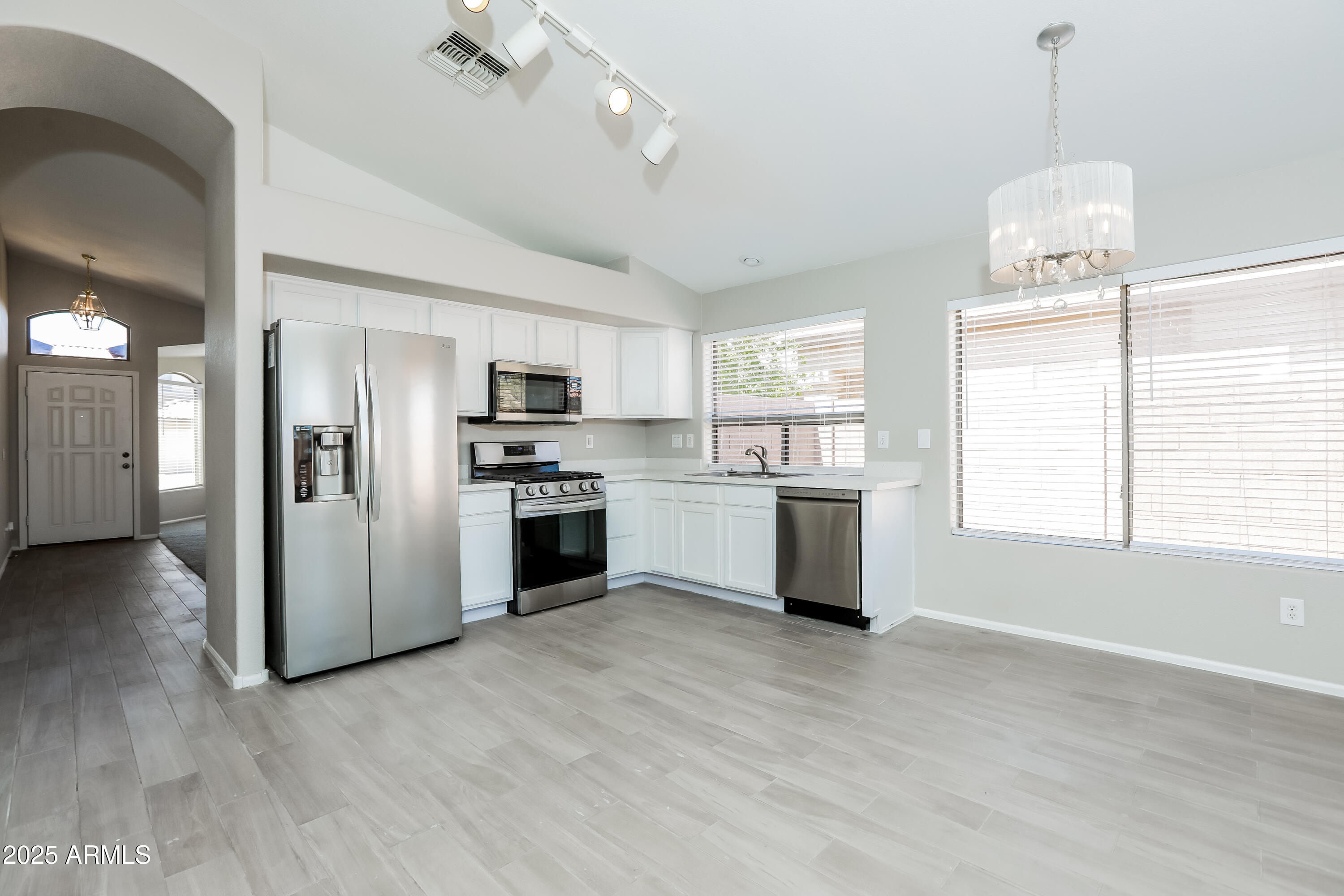 42430 Chambers Drive Maricopa, AZ 85138 - Photo 4 of 15 a kitchen with a refrigerator and a stove top oven