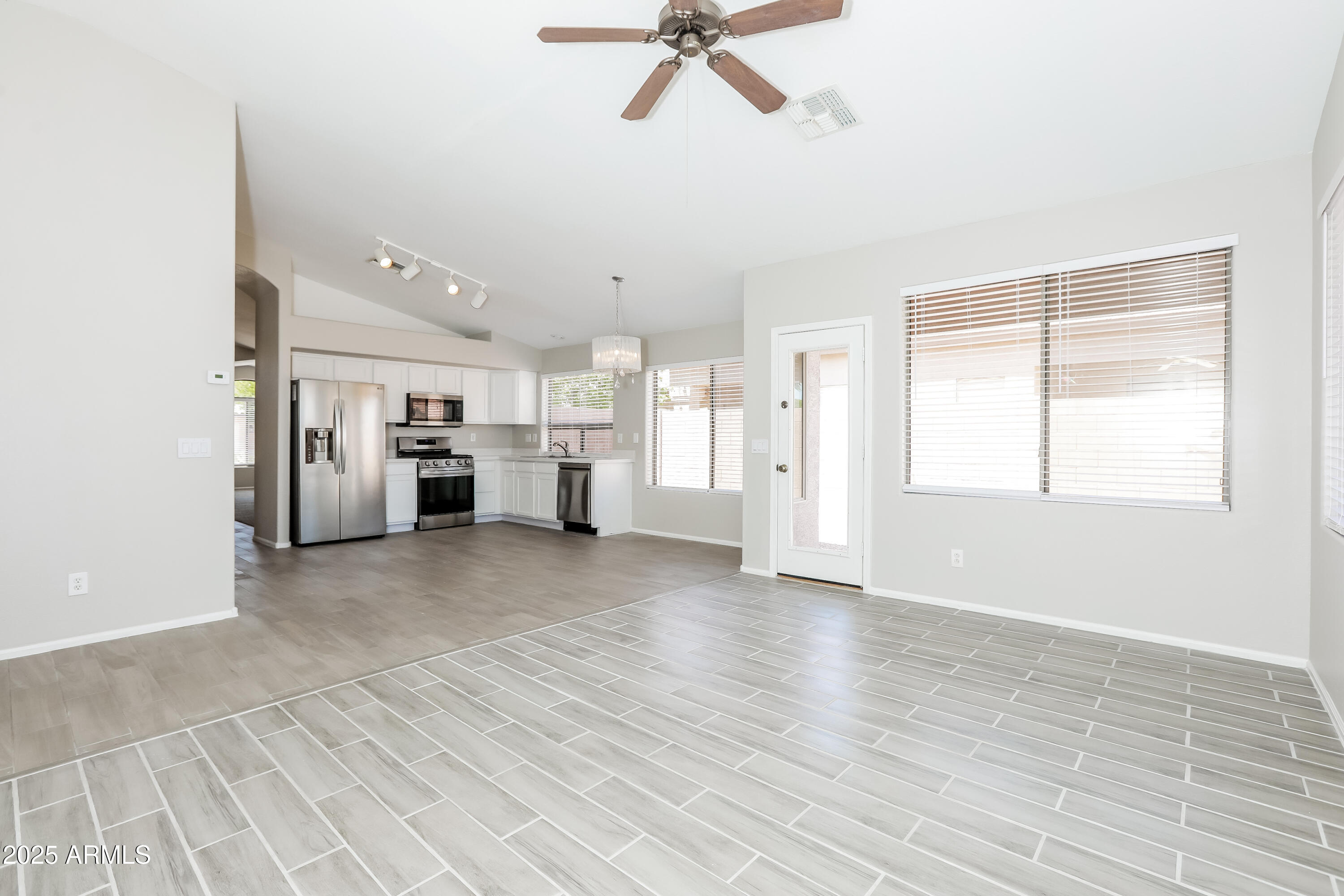 42430 Chambers Drive Maricopa, AZ 85138 - Photo 6 of 15 a view of a kitchen with a stove cabinets and a ceiling fan