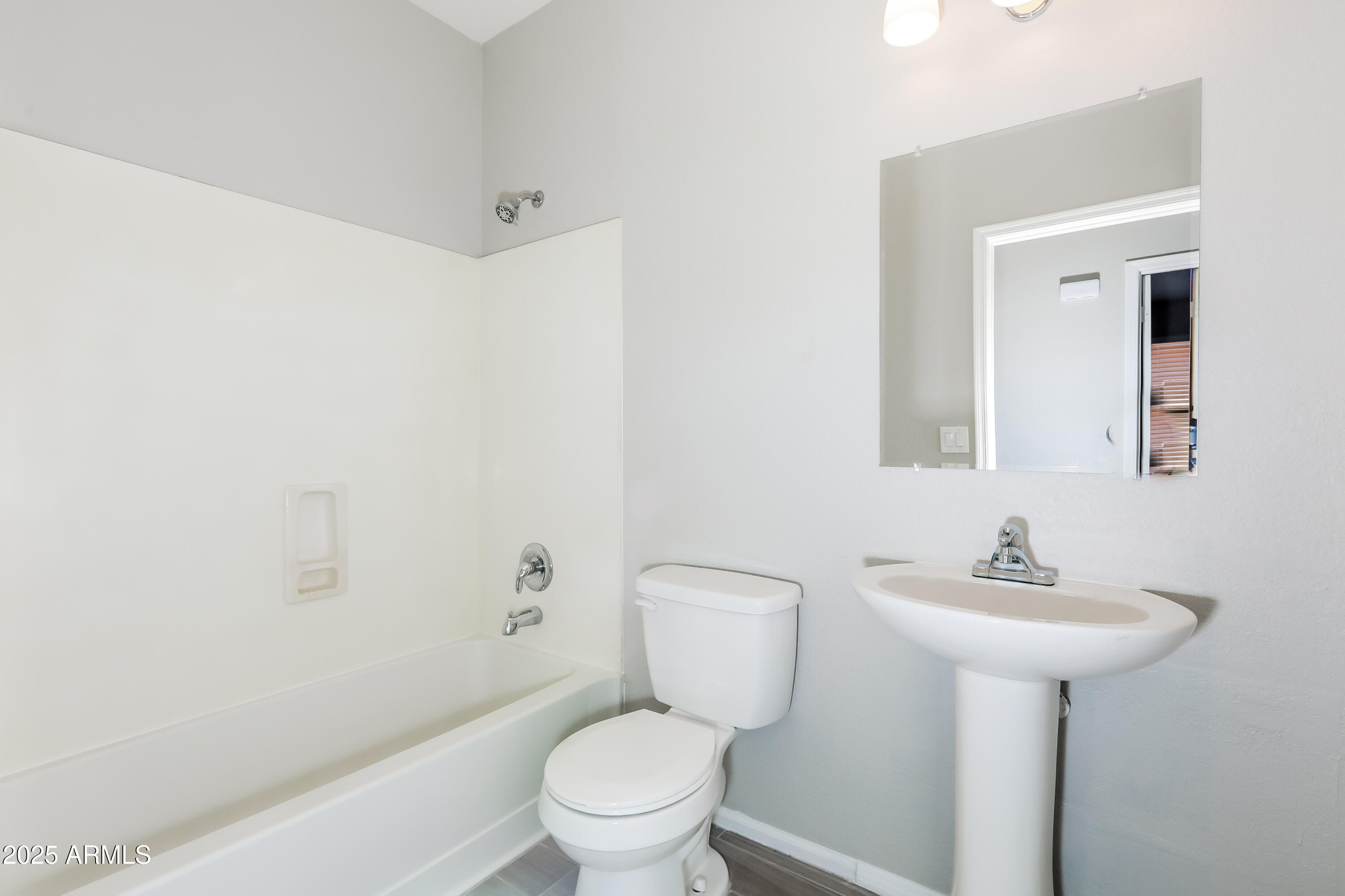 42430 Chambers Drive Maricopa, AZ 85138 - Photo 7 of 15 a bathroom with a sink toilet and a mirror