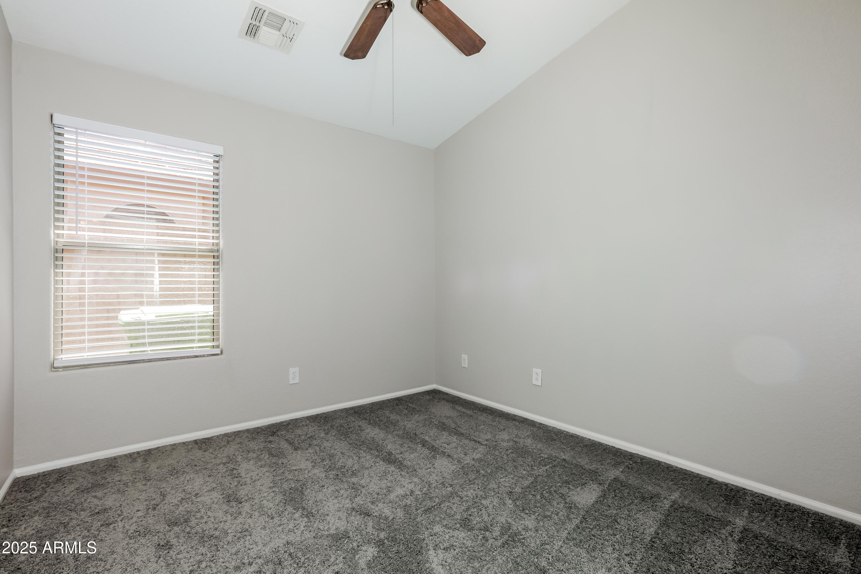 42430 Chambers Drive Maricopa, AZ 85138 - Photo 8 of 15 an empty room with a window and a fan