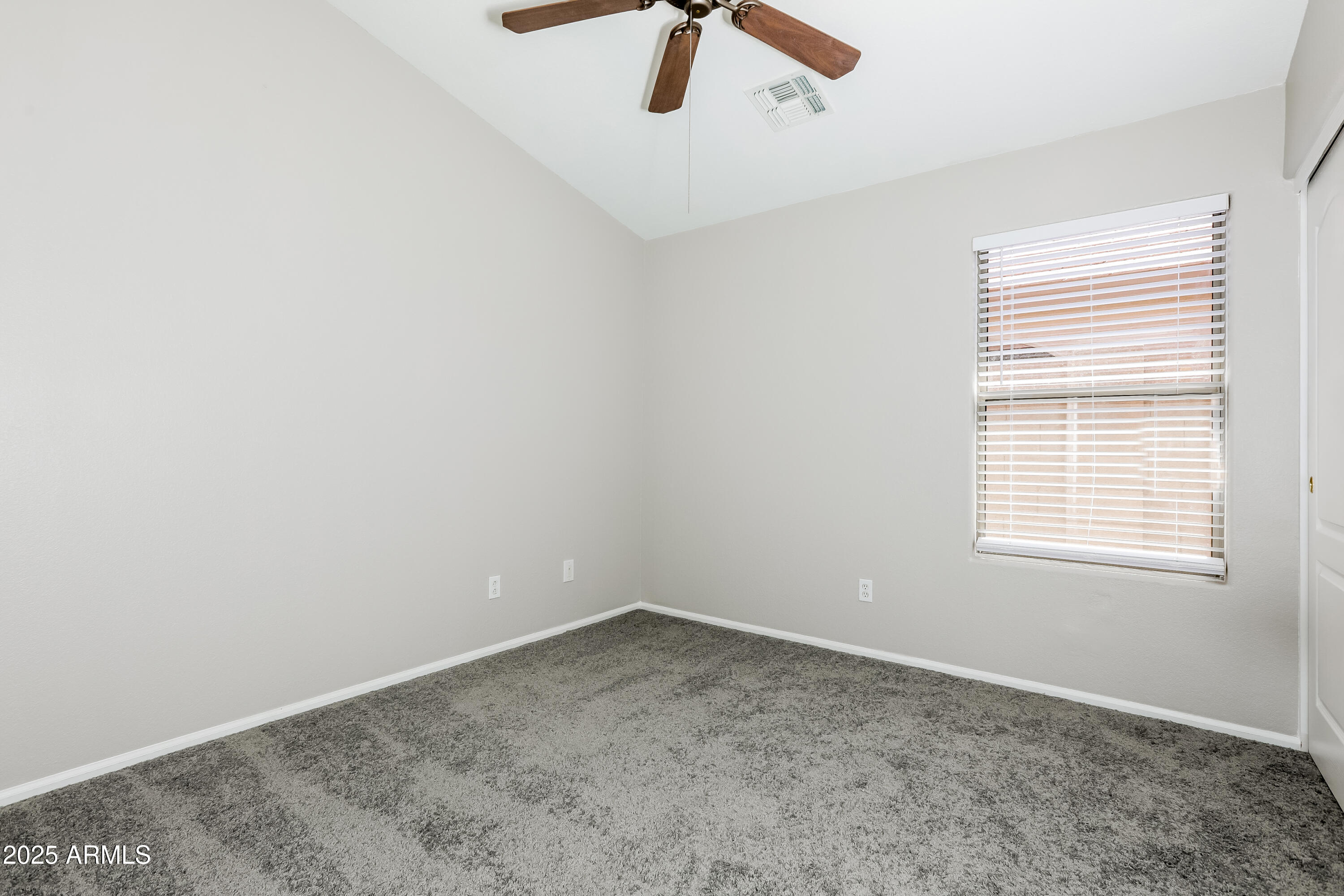 42430 Chambers Drive Maricopa, AZ 85138 - Photo 9 of 15 an empty room with a ceiling fan and window