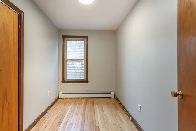 a view of a room with wooden floor and window