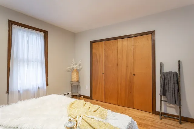 a bed room with a bed and a mirror