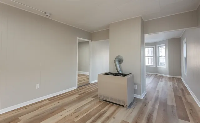 a view of a room with wooden floor and fan
