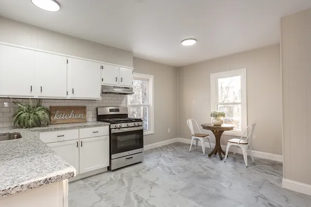 a kitchen with cabinets appliances and a window