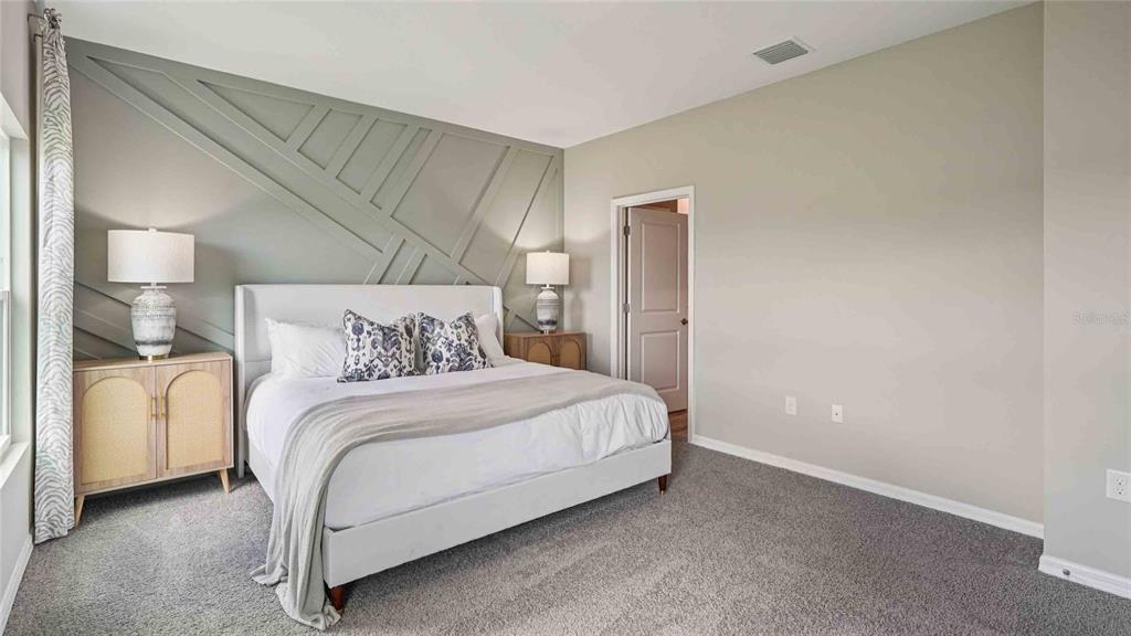 4623 Kona Circle Spring Hill, FL 34608 - Photo 12 of 25 a bedroom with a bed and a lamp