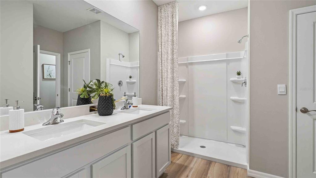 4623 Kona Circle Spring Hill, FL 34608 - Photo 13 of 25 a bathroom with a sink and a mirror with toilet