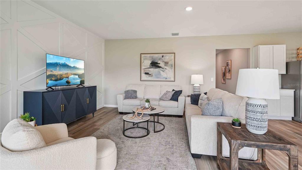 4623 Kona Circle Spring Hill, FL 34608 - Photo 8 of 25 a living room with furniture a rug and wall painting