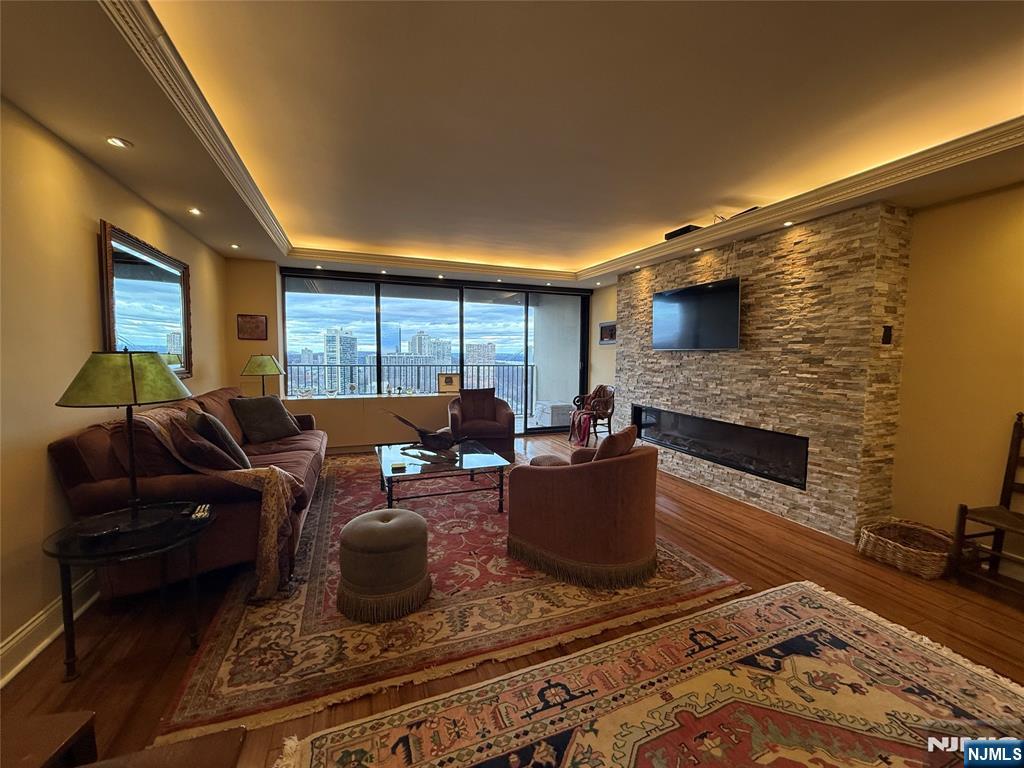 5 Horizon Road, Unit 2504 Fort Lee, NJ 07024 - Photo 17 of 41 a living room with furniture a rug and a fireplace