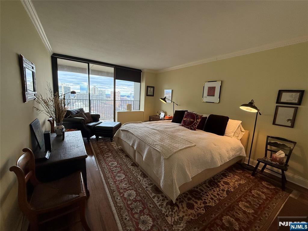 5 Horizon Road, Unit 2504 Fort Lee, NJ 07024 - Photo 34 of 41 a bed room with a bed a couch and a large window