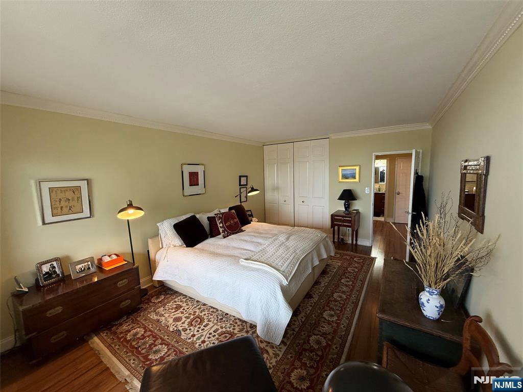 5 Horizon Road, Unit 2504 Fort Lee, NJ 07024 - Photo 35 of 41 a bedroom with a bed and wooden floor