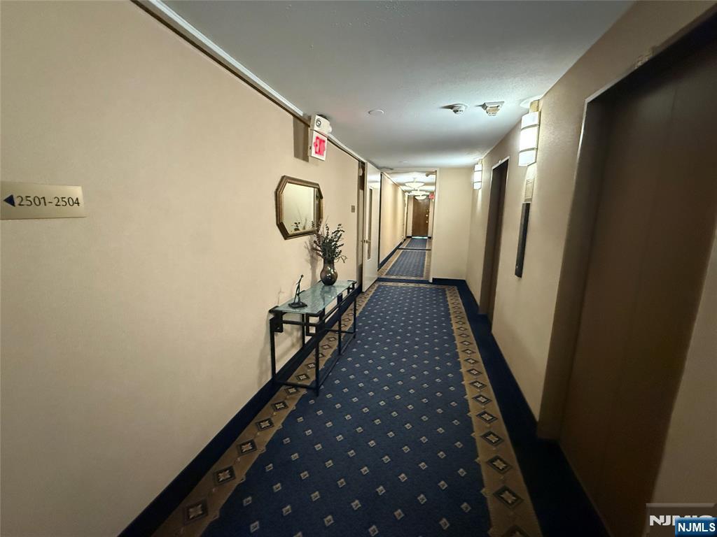 5 Horizon Road, Unit 2504 Fort Lee, NJ 07024 - Photo 9 of 41 a view of a hallway with wooden floor and staircase