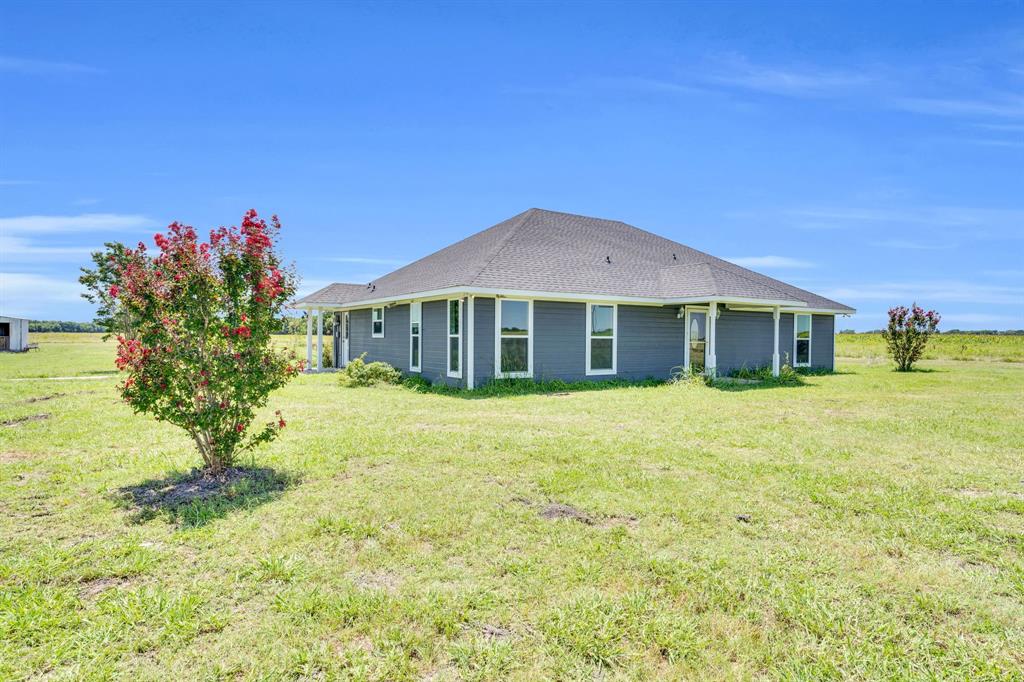 1139 Trumbull Road Ferris, TX 75125 - Photo 1 of 1 Rear view of property featuring a lawn