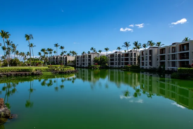 a view of a lake with houses in the back