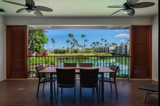 a dining room with furniture a floor to ceiling window and wooden floor