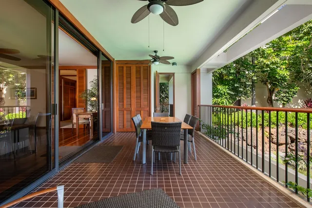 a dining room with furniture a chandelier and wooden floor