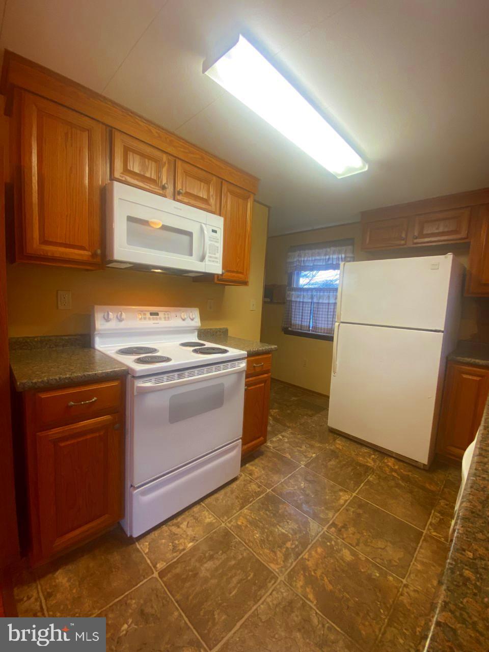 2722 Rowe Road New Windsor, MD 21776 - Photo 12 of 24 Newer stove (2018) and microwave (2022)