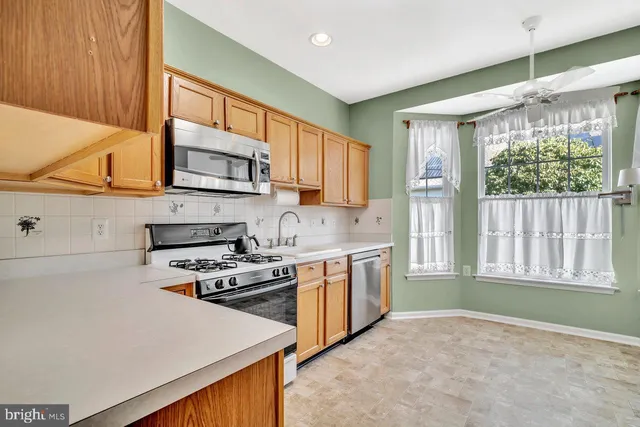 a kitchen with stainless steel appliances a stove sink and cabinets