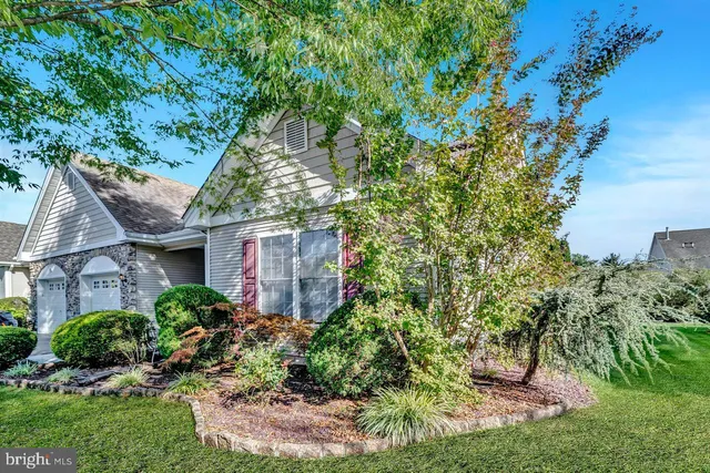 front view of a house with a tree