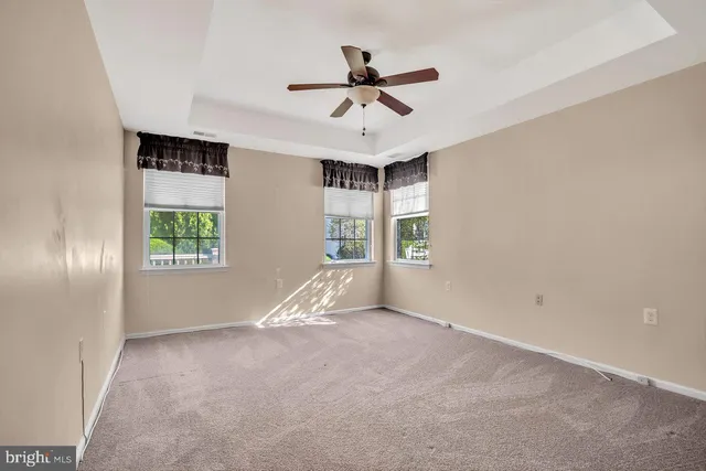 a view of a livingroom with a ceiling fan and window