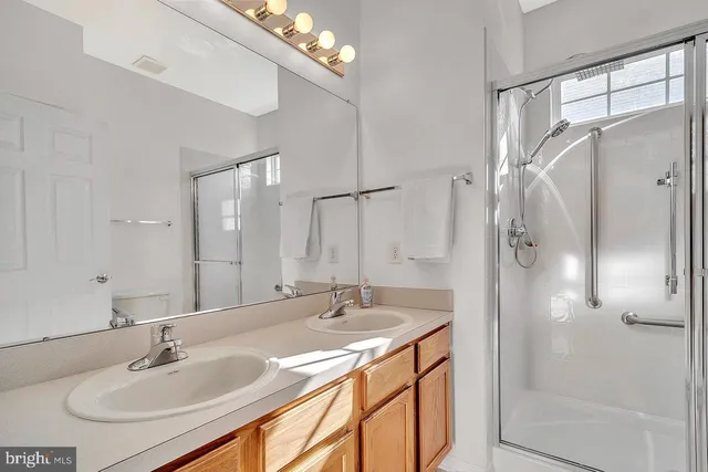 a bathroom with a sink double vanity and shower