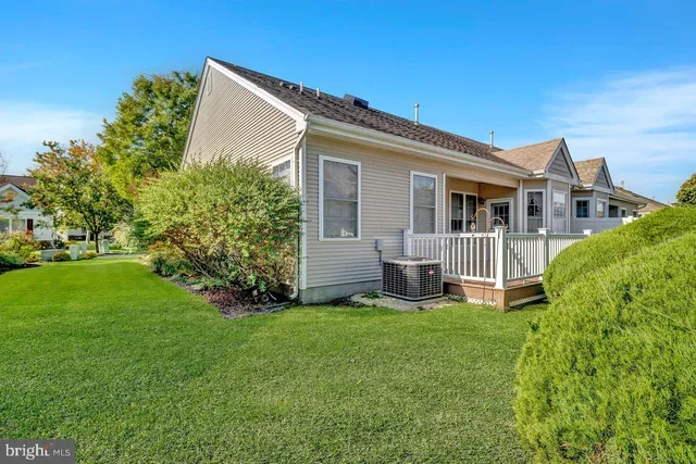 a view of a house with a yard and sitting area