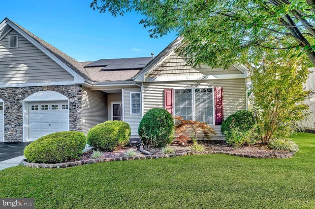 a view of a house with a yard and plants