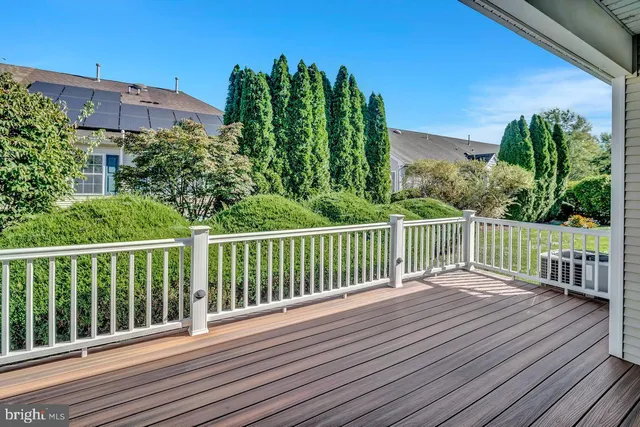 a view of balcony with wooden floor and fence