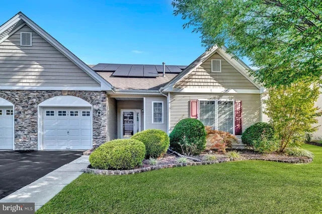 a front view of a house with a yard and porch