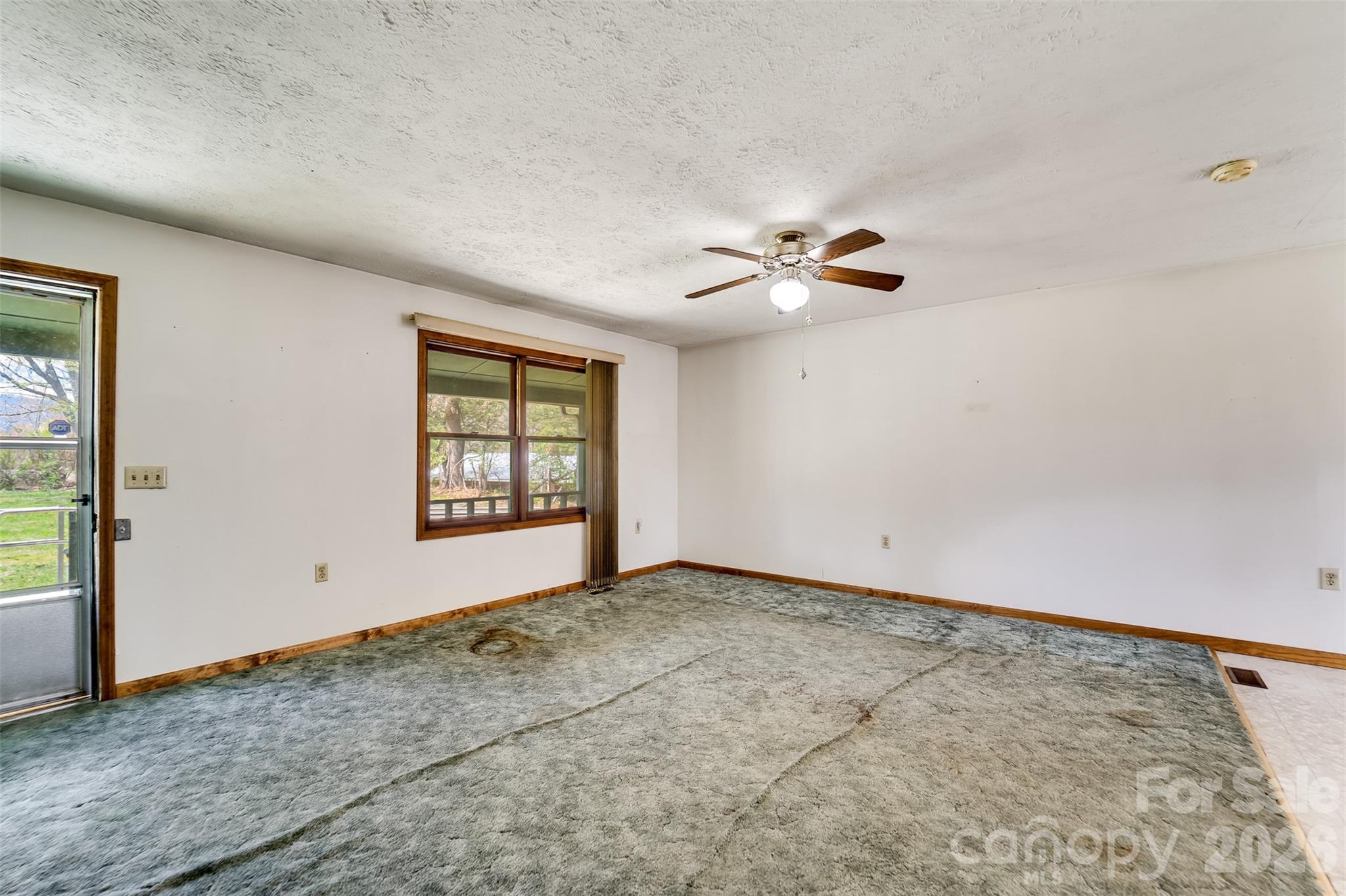 21 Queen Street Sylva, NC 28779 - Photo 5 of 45 an empty room with windows and fan