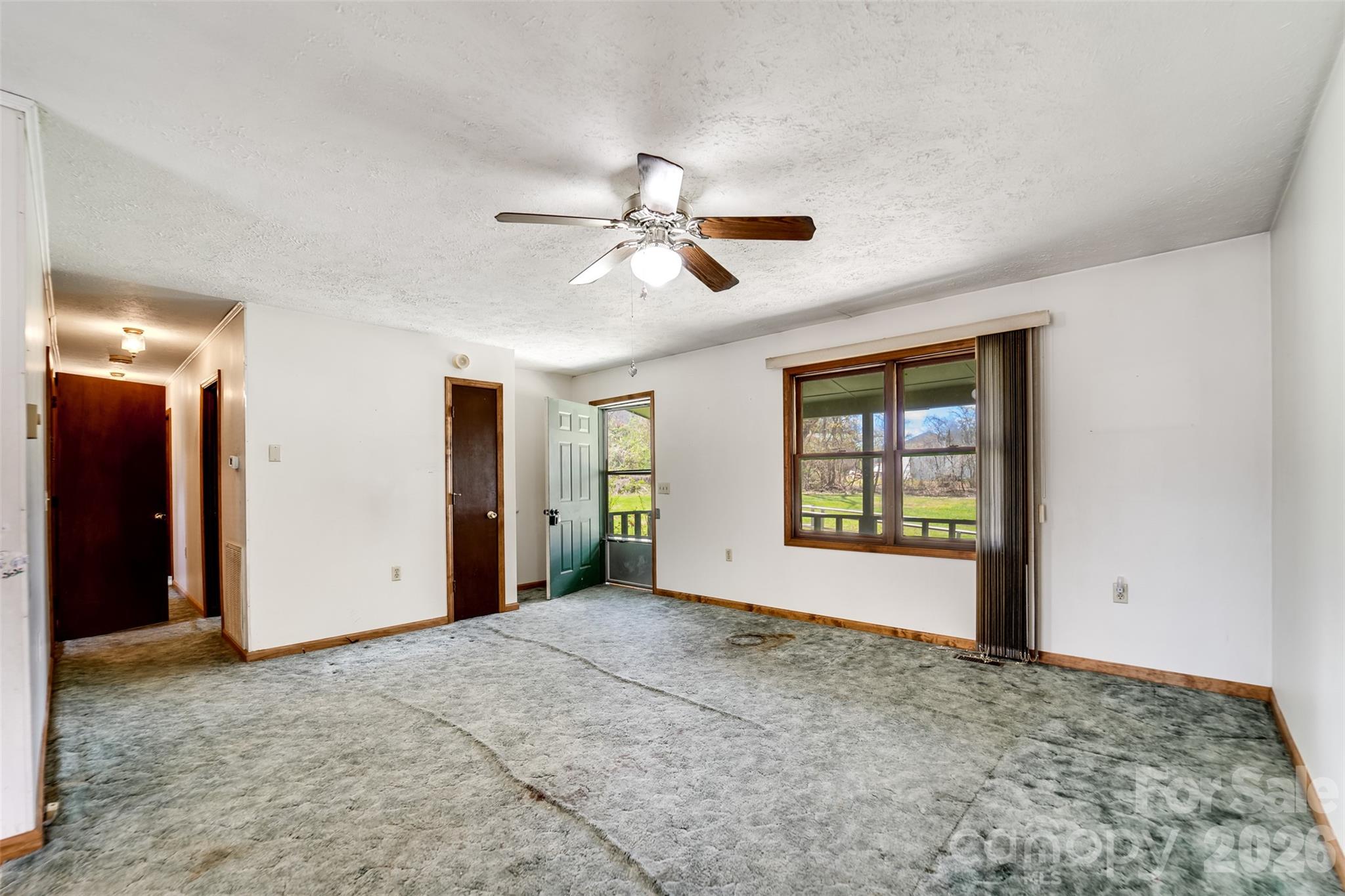 21 Queen Street Sylva, NC 28779 - Photo 6 of 45 a view of a big room with windows and chandelier fan