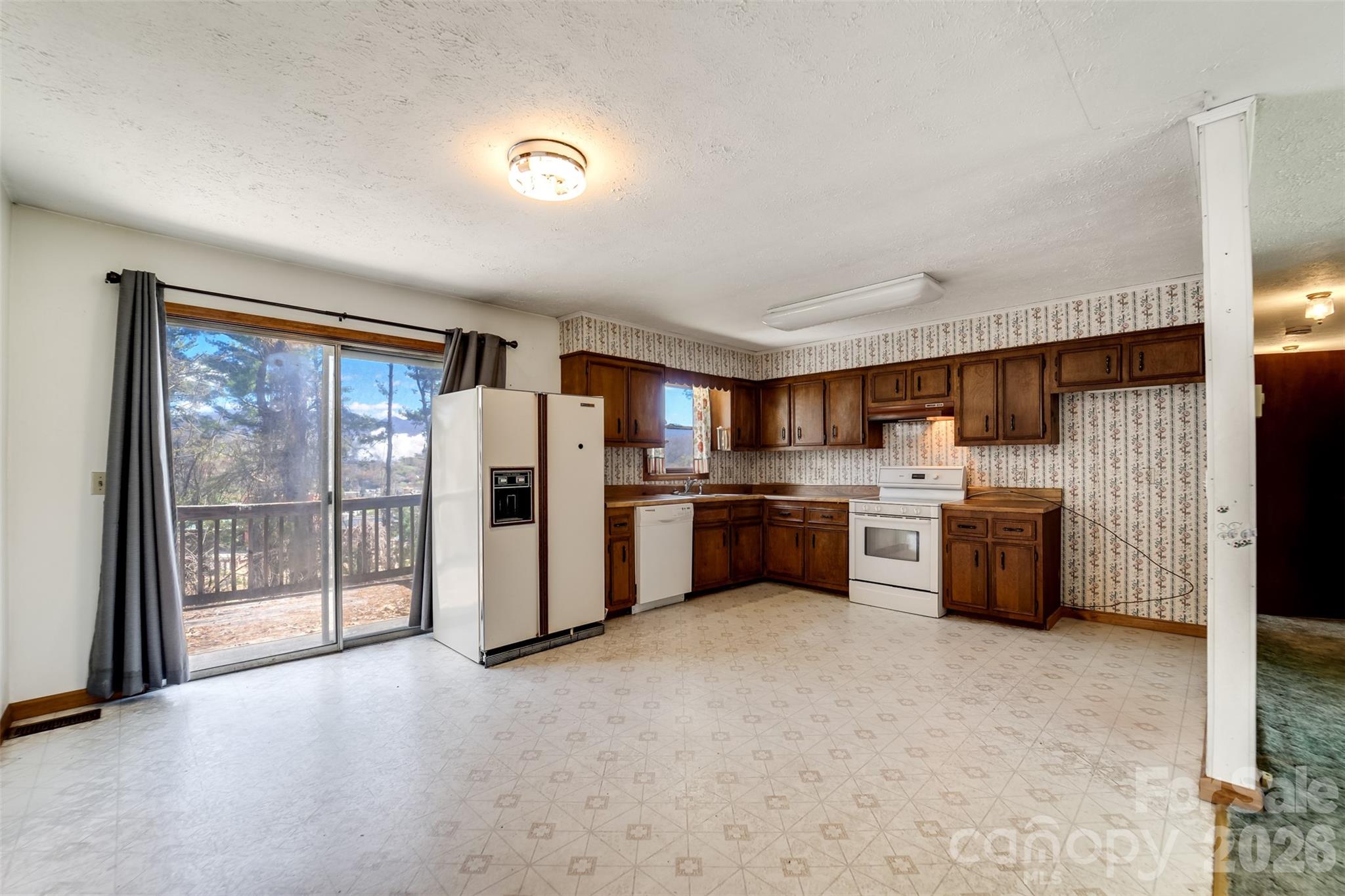 21 Queen Street Sylva, NC 28779 - Photo 7 of 45 a kitchen with stainless steel appliances a refrigerator and a sink