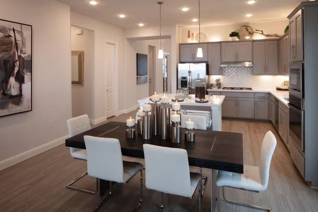a kitchen with kitchen island a sink stove and refrigerator