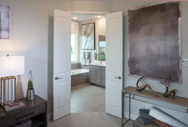 a bathroom with a tub sink and mirror