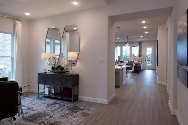 a kitchen with kitchen island granite countertop a sink and wooden floors