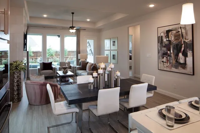 a living room with furniture a large window and a fireplace